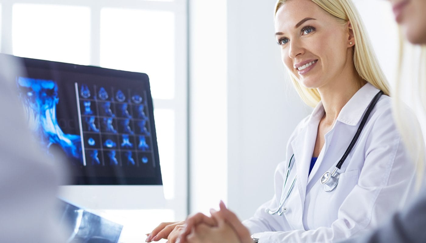 a dentist reviews a x-ray with the patient